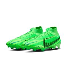 a pair of green soccer shoes on a white background