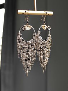 This tassel earring features a combination of black spinel and silver plated Labradorite, with a oxidized silver hoops in the middle and finely crafted textures. The other parts of the metal are matched with 14k gold-filled, and they shine together very brightly and have a gentle feeling, without putting any burden on the earlobes. ●black spinel ●silver plated labradorite ●oxidized silver ●14k gold filled ●mother of pearl flower ● total length: 3.58 inches ● weight：4.8g Welcome to visit my Jewelry store: https://www.etsy.com/shop/Ukuly 🌸The delivery time to Most regions of North America, Australia and Europe is usually about 10-15 days. Buyers from Brazil, South Korea, and Indonesia, please provide me with your tax number through messages or notes for smooth shipment. Thank you. 🌸Please Elegant Black Fringe Chandelier Earrings, Bohemian Dangle Earrings For Evening, Unique Dangle Tassel Jewelry, Elegant Handmade Long Drop Tassel Earrings, Elegant Long Drop Handmade Tassel Earrings, Handmade Evening Chandelier Dangle Earrings, Dangle Tassel Chandelier Earrings, Bohemian Dangle Chandelier Earrings For Evening, Bohemian Tassel Earrings For Evening