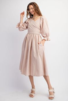 This dress features a sweetheart neckline and bubble sleeves with elasticized cuffs, as well as a smocked waistline and back. The adjustable top allows for multiple looks, and the side pockets add functionality. Its loose and flowy fit offers comfort and style. Length measures at 45.5" with a bust measurement of 14.5". 100% Cotton Spring Midi Dress With Balloon Sleeves For Daywear, Spring Puff Sleeve Dress With Bishop Sleeves For Daywear, Spring Daywear Midi Dress With Balloon Sleeves, Spring Daywear Puff Sleeve Dress With Bishop Sleeves, Spring Balloon Sleeve Midi Dress For Daywear, Spring Midi Dress With Balloon Sleeves For Brunch, Summer Long Sleeve Puff Dress With Pleated Sleeves, Casual Spring Midi Dress With Balloon Sleeves, Modest Midi-length Puff Sleeve Dress With Gathered Sleeves