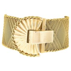 You are looking at a magnificent vintage strap bracelet that was crafted in Italy from solid 18k yellow gold. This wide strap is very well constructed from woven mesh with a silky and super flexible feel on the wrist. The mesh strap is embedded with a beautiful crossed pattern throughout and is neatly bordered with rope chain along both sides, all of which brings a super elegant look to this piece. The large and fancy fold-over clasp features a scalloped and fanned out design with a nice high-polished finish and is further detailed with bead work along with a rope chain border as well. This outstanding vintage piece remains in excellent condition and is absolutely guaranteed to make a bold yet elegant statement! Enjoy :) -- Item Details -- Material: Solid 18k Yellow Gold Weight: 62.44 Gram Fancy Folds, Statement Bracelet, Vintage Italian, Rope Chain, Wide Straps, Chain Bracelet, Bead Work, Jewelry Bracelets, 18k Gold