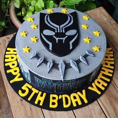 a star wars themed birthday cake on a wooden table