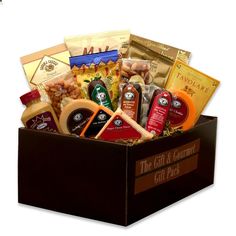 the gift and gourmet box is packed with cheeses, condiments, sauces and crackers