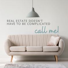 a couch sitting in front of a wall with the words real estate doesn't have to be complicated call me