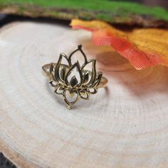 Bohemian Adjustable Brass Ring in the Shape of a Lotus.  The Lotus Is A Spiritual Symbol Signifying Purity And Spiritual Elevation You Can Adjust This Ring Directly On Your Finger Because It Is Flexible. -Size: Adjustable -Materials: Brass -Color: Golden or Silvered -Diameter of the ring at the widest: 2 cm -Style: Bohemian -Handmade -Delivered in a Cloth Pouch Ideal for Gifting *◅ ↠ ☽ ◅* + *▻ ☾  ↠You Can Paired It With These Earrings: https://www.etsy.com/fr/listing/1348252847/petites-boucles-doreilles-pendantes?ref=listings_manager_grid ↠ This Other Ring: https://www.etsy.com/fr/listing/1469952106/bague-ajustable-lotus-avec-pierre-semi?ref=listings_manager_grid ↠  This Pendant: https://www.etsy.com/fr/listing/1237964834/pendentif-lotus-avec-pierre-semi?ref=listings_manager_grid ↠ You Mig Adjustable Spiritual Rings, Gold Spiritual Flower Ring For Gift, Adjustable Gold Flower Ring Nature-inspired, Adjustable Gold Flower Ring, Nature-inspired, Handmade Jewelry Ring For Meditation, Bohemian Flower Ring As A Gift, Adjustable Bohemian Flower Ring, Bohemian Adjustable Midi Rings For Wedding, Bohemian Brass Jewelry For Meditation