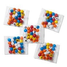 three bags filled with lots of different colored candies on top of eachother