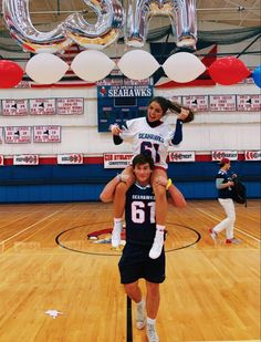 two people are doing acrobatic tricks on the basketball court