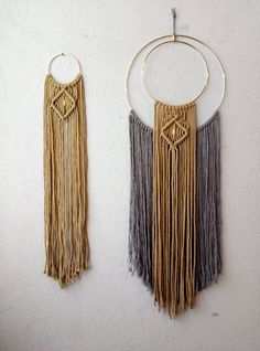 two wall hangings made out of macrame and metal rings with chains attached to them