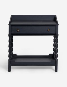 the side table is black and has two drawers on one end, and an open drawer on