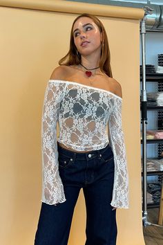 Also available in Black. Styled with the Avery Dark Denim Low Rise Jeans. Product Deets White lace off the shoulder long sleeve top 95% nylon, 5% spandex Floral lace fabric Elastic trim around top with scalloped edge detail Flare sleeve Full length top Size small measures 14” long Runs true to size Model Info Meghan is 5’6. Waist: 26" Bust: 34A Wearing size Small. Stretch Long Sleeve Off-shoulder Top For Summer, Non-stretch Lace Top For Spring, Spring Stretch Lace Top With Patchwork, Spring Stretch Lace Patchwork Top, Spring Stretch Long Sleeve Off-shoulder Top, Long Sleeve Stretch Tops With Lace Patchwork, Stretch Long Sleeve Top With Lace Patchwork, Long Sleeve Tops With Lace Patchwork And Stretch, Stretch Long Sleeve Tops With Lace Patchwork