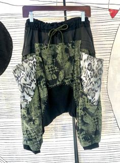 This is very comfy and unique drop pants. The waist is flexible and unique design pockets. Size              Medium  Waist 32-38    Hip 50   Length 30 Green Harem Pants With Pockets For Loungewear, Green Cargo Bottoms For Loungewear, Green Baggy Patchwork Pants, Baggy Green Patchwork Pants, Green Stretch Harem Pants With Pockets, Green Baggy Harem Pants For Loungewear, Baggy Green Harem Pants For Loungewear, Stretch Green Harem Pants With Pockets, Green Harem Bottoms With Pockets