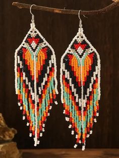 Add a touch of bohemian elegance to your style with these exquisite handmade glass bead earrings. Crafted with love and care, these intricate earrings feature a beautiful design showcasing a harmonious blend of orange, red, black, white, and turquoise beads. Inspired by American Indian and Indigenous designs, these earrings are perfect for adding a pop of color and a unique flair to any outfit. The stunning array of colors brings warmth and vibrancy, making these earrings a standout accessory for any occasion. Embrace the blend of boho chic and heartfelt artistry with these captivating earrings. Bohemian Teardrop Beaded Earrings With Colorful Beads, Traditional Multicolor Beaded Fringe Chandelier Earrings, Multicolor Bohemian Tassel Earrings, Bohemian Multicolor Tassel Earrings, Bohemian Orange Tassel Earrings, Bohemian Teardrop Dangling Beads, Artisan Multicolor Beaded Tassel Earrings, Bohemian Dangle Beaded Earrings With Colorful Beads, Multicolor Beaded Tassel Earrings As Gift