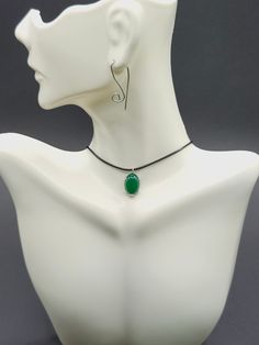 Explore our exquisite collection that showcases the natural beauty of jade. Our jade necklace or pendant showcases the rich green tones of this stunning gemstone, perfect for adding elegance to any outfit. The collection includes stylish Y2K necklaces (classic Jade necklaces), offering a mix of modern and timeless styles. For a versatile look, the Black cord necklace provides minimalist appeal, while the 925 sterling silver mounting adds a sophisticated touch. The jade pendant features an adjustable design for a comfortable fit. Whether you are looking for a protective amulet or a fashion accessory, our jade jewelry collection has something unique and meaningful for any occasion. Details: *Handmade item, gift wrap *Ships from Florida, USA *Materials: cord, Sterling Silver charm, Nephrite * Green Spiritual Jewelry With Adjustable Cord, Elegant Adjustable Emerald Necklace Gift, Elegant Nickel-free Jade Necklaces, Elegant Sterling Silver Necklace With Adjustable Cord, Elegant Adjustable Cord Choker As Gift, Elegant Adjustable Cord Necklace For Gift, Elegant Adjustable Cord Choker, Green Pendant Jewelry With Adjustable Cord, Adjustable Natural Stones Emerald Necklace Gift