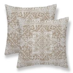 two beige pillows with an intricate design on the front and back, both made out of linen