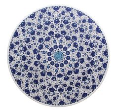 a blue and white plate with an intricate design on the top, in front of a white background