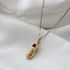 "Solid 14k Yellow Gold Puffy Soccer Shoe Necklace, Soccer Shoe Pendant with Box Chain, Soccer Shoe Necklace Charm, 14K Gold Soccer Shoe Charm, Can be worn with other necklaces, great for layers. A Perfect 14K Gold gift. . . . * Pendants Measurements With Bail: (28 x 9 mm) * Chain is included ( 1MM Box Chain) * Stamp: Real 14k Gold * Never gold filled or plated * Packaged With Free Gift Box . . . . If you have any questions, just hit the \"Message the Seller\" button ( bottom right of the page) a Yellow Gold Charms Necklace Keepsake, Yellow Gold Pendant Charm Necklace With Box Chain, Yellow Gold Charm Necklaces For Keepsake, Yellow Gold Charm Necklace For Keepsake, Yellow Gold Plated Charm Necklace With Box Chain, 14k Yellow Gold Charm Necklace With Box Chain, Yellow Gold-plated Charm Necklace With Box Chain, 14k Gold Charm Necklace With Box Chain, 14k Gold Charms Necklace For Keepsake