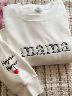 Custom Embroidered Mama, Grandma Floral Sweatshirt, Embroidered Floral Mama sweatshirt, gift for her, gift for friend, gift for mama 🌸HOW TO ORDER: Please check our size and color charts to get exactly what you want. Select the correct size and color and fill out the personalization box 🌸ABOUT OUR SWEATSHIRTS/HOODIES: 35% Cotton, 65% Polyester Machine cold wash, inside out, with like colors. Lay flat to dry. Please do not bleach. Please do not iron. Sizes are standard Unisex and run true to size. If women want a loose fit, they should order their usual size. Size down for a fitted look; size up one or two sizes for the oversized/baggy look. Please double-check our size chart to get the right size for you! 🌸Don't forget to check out the rest of our listings for more custom embroidery, an White Cotton Sweatshirt With Custom Embroidery, Gift Sweatshirt With Embroidered Text And Long Sleeves, Custom Embroidered White Tops For Mother's Day, Embroidered Logo Sweatshirt As A Gift, Long Sleeve Sweatshirt With Embroidered Logo Gift, Long Sleeve Tops With Multicolor Embroidery And Letter Print, Embroidered Logo Long Sleeve Sweatshirt, White Tops With Embroidered Graphics For Mother's Day, Multicolor Embroidery Long Sleeve Top With Letter Print