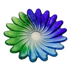 a blue and green flower with water droplets on it's petals in the shape of a sunflower