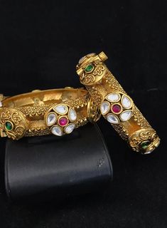 Simply a mark of royalty and elegance!! Handcrafted in brass with gold plating and fine quality Kundan stones. Set of 2 For wrist Size 2.4 Inner Diameter: 2.25 inches Easily Openable with a screw The bangles are the same as shown in the pictures. We have only one piece in this color and design, hence you get what you see in the pictures. Antique Gold Plated Jewelry For Wedding, Antique Gold Plated Wedding Jewelry, Antique Gold-plated Wedding Jewelry, Gold Bracelets With Intricate Design For Marriage, Gold Bracelets With Detailed Design For Marriage, Gold Jeweled Bangle For Festivals, Gold Bracelet For Wedding And Festivals, Gold Wedding Bracelet For Festivals, Elegant Gold Jeweled Bangle