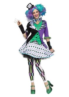 a woman dressed as a clown with green hair and purple wig, holding a glass in her hand