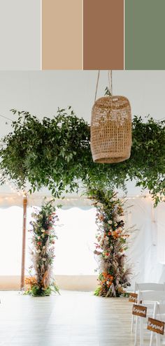 an indoor wedding venue with white chairs and greenery on the ceiling, along with color swatches