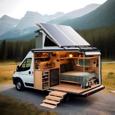 a tiny house with a bed and stairs in the back is parked on the side of the road