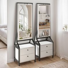 two mirrors sitting next to each other on top of a wooden floor in front of a bed