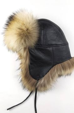 A fluffy hat that will always amaze by its beauty. A regal hat produced for warm-lovers and generally for those who want something majestical to bedeck their head with the most outstanding and massive way. An aviator style hat made with black napa sheepskin and extra heavy long-haired finn Raccoon skin. It has earflaps that can be adjusted to any high with leather straps that can be tied under the chin, on top of hat and at back of the head. Product description: 100% handmade product Natural mat Women Winter Hat, Fur Trapper Hat, Fur Trapper, Trapper Hat, Trapper Hats, Hat For Men, Aviator Style, Fur Hat, Winter Hats For Women