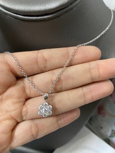 "This is a 14K White Gold Cluster/Flower Pendant with excellent quality simulated diamonds. Hung from a 14K White Gold 18\" Cable Link Chain. A perfect way to elegantly dress up any outfit. This pendant will sparkle under any lighting. The cable link chain is delicate yet strong and also shines beautifully. You'll be sure to receive numerous compliments. PENDANT ~ 100% 14K White Gold ~ High-quality Simulated Diamonds (CZ) ~ About 0.60 inches WITH BAIL (height) CABLE CHAIN ~ 100% 14K White Gold ~ Sparkling Diamond White Necklace For Parties, Formal Diamond White Diamond Necklace With Sparkling Stones, Formal Diamond White Necklace With Sparkling Stones, Formal Round Cut Diamond Necklace With Sparkling Stones, Elegant Diamond White Necklace With Sparkling Stones, Elegant Diamond White Diamond Necklace With Sparkling Stones, Glamorous Cubic Zirconia Diamond Necklace For Formal Events, Elegant Party Diamond Necklace With Diamond Cut, Elegant Sparkling Diamond Necklace For Wedding