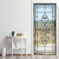 a room with a table and a glass door that has a decorative design on it