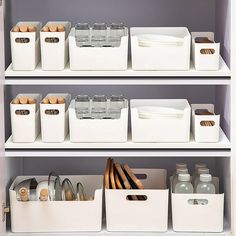 the shelves are organized with plastic containers and utensils in white bins on them