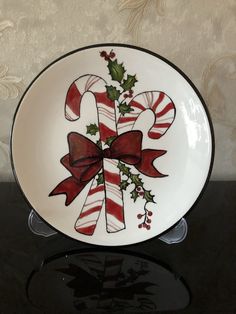 a plate decorated with candy canes and holly