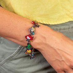 a person wearing a bracelet with cartoon characters on it