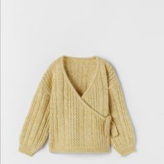 an image of a child's sweater with a wrap around the neck and long sleeves