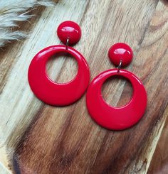 Oversized drop hoop earrings, handmade in raspberry red resin and finished with stainless steel earrings posts. The hoops are 42mm in diameter and the earrings have a drop length of 62mm. These large drop hoop earrings have a classic 50s Rockabilly look and will look amazing if you're glammed up for a night out and also with jeans for a more casual look. They are made in lightweight resin, making them easy to wear for long periods and will be the perfect Valentines gift for loved ones. Please get in touch if you'd like these in a different colour combination, tops and hoops can be mixed or alternated if you would like mis-matched earrings. You can find more of my 50s and 60s drop hoop earrings here: www.etsy.com/uk/shop/RosieMays?section_id=25135598 Thank you for visiting. Rockabilly Looks, Oversized Hoop Earrings, Resin Making, Hoop Earrings Handmade, 50s Rockabilly, Drop Hoop Earrings, Rockabilly Style, Raspberry Red, Resin Design