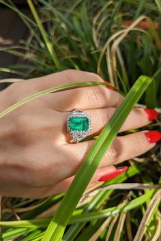 An emerald ring will definitely become the best companion in making aesthetic outfits. Its beautiful green glow will add charm to any clothing and will be perfectly combined with it. Also, an emerald ring will be a great gift for any holiday, such as New Year, Christmas, Easter and Mother's Day! Luxury Gia Certified Emerald Diamond Ring, Luxury Diamond Cluster Ring With Gemstones, Luxury Emerald Cluster Ring With Vvs Clarity, Gia Certified Diamond Emerald Ring For Formal Occasions, Gia Certified Emerald Diamond Ring For Formal Occasions, Gia Certified Diamond Cluster Ring For Formal Occasions, Formal Gia Certified Diamond Emerald Ring, Luxury Emerald Cut Cluster Ring With Center Stone, Luxury Cluster Ring With Emerald Cut Center Stone