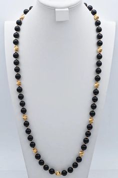 Embrace sophistication with our Vintage 14K Yellow Gold Black Onyx Beaded Strand Necklace. This 35-inch stunner exudes classic charm, making a bold statement in any ensemble. Elevate your style game with this exquisite piece! #VintageJewelry #OnyxNecklace #GoldBeadedStrand Luxury Black Necklace With Polished Beads, Luxury Black Polished Beads Jewelry, Luxury Black Jewelry With Polished Beads, Luxury Black Polished Bead Jewelry, Elegant Polished Yellow Gold Beads, Black Onyx Jewelry With Polished Beads, Elegant Yellow Gold Polished Beads, Classic Onyx Beaded Necklace With Black Beads, Elegant Onyx Beaded Necklaces For Formal Occasions