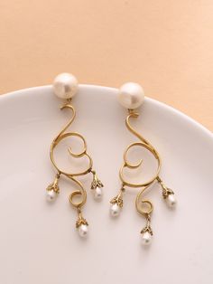 ♥ Dangling brass long earring ♥ Ethnic Pearl danglers in bohemian style, Tear drop pearls set in a curvy design. 18K Gold plated brass earrings. These danglers are super chic, versatile, light weight and hassle free. What makes it different in terms of design is the texture technique which is exclusively hand made. Grab these beauties !! WHY - YOU'LL - LOVE - IT * It's dainty and can be worn every day * A special piece you'll treasure * High-quality materials and attention to detail ~Made with L Bohemian Danglers For Wedding, Gold Metal Linear Earrings For Wedding, Yellow Gold Metal Chandelier Earrings For Wedding, Wedding Chandelier Earrings In Yellow Gold, Wedding Yellow Gold Chandelier Earrings, Formal Brass Earrings With Latkans, Metal Pierced Danglers For Wedding, Elegant Festive Pearl Earrings, Elegant Latkans Earrings For Formal Occasions