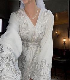 a woman wearing a white wedding dress and veil