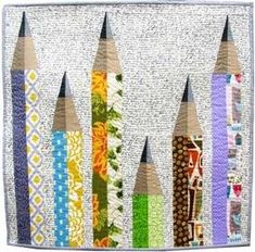 several pencils are lined up on a piece of fabric