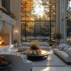 a living room filled with furniture and a fire place in front of a large window