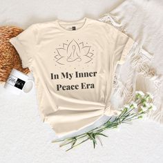 Express the tranquility of your "Inner Peace Era" with this t-shirt, designed to elevate your style and soothe your soul. Crafted with care and attention to detail, this shirt is more than just apparel--it's a wearable affirmation of mindfulness and inner harmony. Made from premium materials for ultimate comfort, our zen-inspired design is perfect for yoga sessions, meditation practices, or simply lounging in comfort and style.  With its minimalist & stylish design, our "In My Inner Peace Era" T Relaxation Graphic Print Crew Neck Top, Graphic Print Crew Neck Tops For Relaxation, Relaxed Fit Graphic Print Tops For Meditation, Crew Neck Top With Graphic Print For Relaxation, Peace Era, Inner Harmony, Meditation Practices, Streetwear Fashion Women, Tshirt Outfits