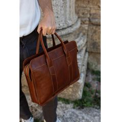 Elevate your professional style with our Handmade Italian Leather Laptop Bag, a perfect blend of luxury and practicality. Crafted from the finest Tuscan vacchetta leather, this laptop bag showcases the rich heritage and artisanal skill of Montepulciano. Designed to accommodate your laptop and essential documents, this bag is ideal for both men and women, making it a perfect choice for business and everyday use. Features:  ● Premium Material: Made from 100% genuine Tuscan vacchetta leather, celeb Elegant Brown Case For Everyday Use, Elegant Everyday Brown Case, Elegant Brown Everyday Case, Professional Leather Satchel For Daily Use, Business Soft Leather Satchel Briefcase, Soft Leather Satchel Briefcase For Business, Professional Brown Satchel For Everyday Use, Business Satchel In Soft Leather, Professional Leather Satchel For Everyday Use