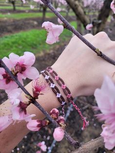 These lovely bracelets are inspired by the beautiful almond blossoms that bloom all over my hometown during the springtime. I've made the bracelet adjustable! Be careful when wearing around water, as friendship bracelets can curl up sometimes. Bohemian Beaded Bracelets For Friendship In Spring, Bohemian Beaded Bracelets For Friendship And Spring, Casual Spring Jewelry For Friendship, Spring Casual Hypoallergenic Jewelry, Casual Hypoallergenic Spring Jewelry, Casual Hypoallergenic Jewelry For Spring, Pink Friendship Bracelets For Spring, Resizable Bracelets For Spring, Spring Adjustable Resizable Bracelets