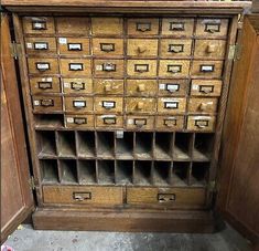 an old wooden filing cabinet with many drawers