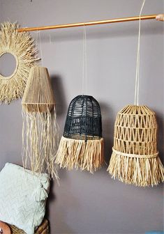 three woven baskets hanging on a wall