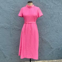 Vintage 1960's Emma Domb mod dress. Great neon pink with short sleeves and bow detail. Cool mod simple design. Has bow at the waist in back that snaps. Perfect party dress for a night out or even a retro bridesmaid. Nice and bold. Dry clean only. Has white lining in armpits by Kleinerts to absorb odor and sweat Size - XS or Small. . Chest - 34 inches, Waist - 28 inches, Length - 43 inches  Material - No materials tag. Lined Condition - Good. Slight age. Bow has some loose threads. See closeups Feel free to message me if you have any questions. Check out my other vintage finds here - http://www.etsy.com/shop/klendovintage Cheers, Kerri Retro Short Sleeve Vintage Dress For Party, Retro Short Sleeve Cocktail Dress, Pink Fitted A-line Vintage Dress, Elegant Short Sleeved Pink Vintage Dress, Pink Vintage Dress For Summer Formal Events, Elegant Pink Vintage Dress With Short Sleeves, Fitted Pink Mod Dress, Pink Fitted Mod Dress, Pink Retro Vintage Dress For Formal Occasions