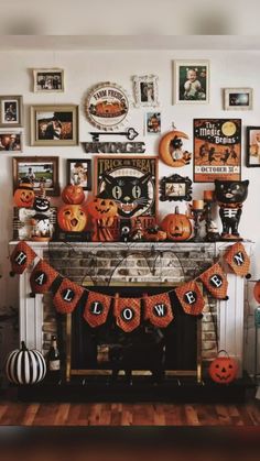 a fireplace decorated for halloween with pumpkins and decorations