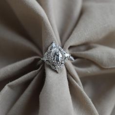 an engagement ring on top of a fabric