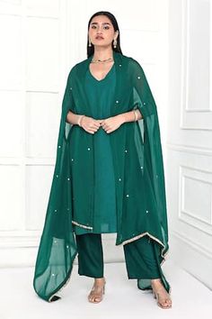 Rama green floral hand embroidered cape. Paired with an inner kurta and pant.
Components: 3
Pattern: Hand Embroidery
Type Of Work: Floral
Neckline: V neck
Sleeve Type: Sleeveless
Fabric: Kurta and Pant: Chanderi, Cape: Organza
Color: Green
Other Details: 
Model Height: 5ft 11inches, wearing size S
Length:
Kurta: 48 inches 
Pant: 37 inches
Attached inner lining
Approx. product weight: 0.750 kg
Occasion: Puja - Aza Fashions Traditional Dupatta With Cape Sleeves For Navratri, Traditional Navratri Dupatta With Cape Sleeves, Diwali Dupatta With Resham Embroidery And Cape Sleeves, Diwali Resham Embroidery Dupatta With Cape Sleeves, Green Palazzo Set With Sheer Dupatta, Green Churidar For Navratri, Traditional Wear With Zari Work And Cape Sleeves, Festive Green Palazzo Set With Cape Sleeves, Green Cape Sleeves Sets For Eid