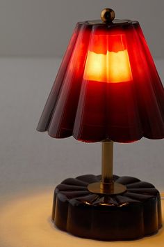 a red lamp sitting on top of a table